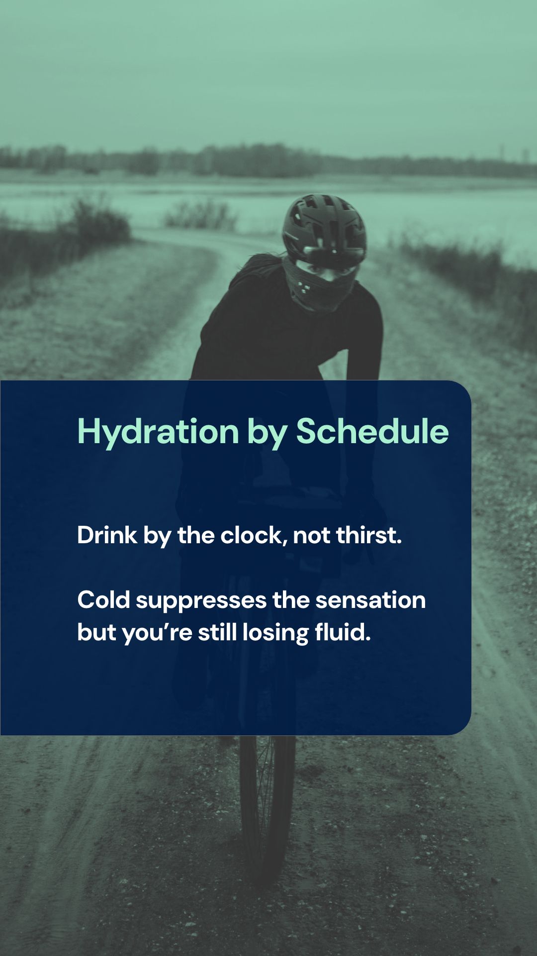 Cyclist drinking from water bottle during cold weather training ride